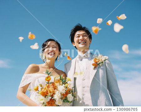 Happy bride and groom smiling under the blue sky 130986705