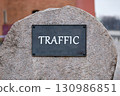 Boost visibility, attract organic traffic, and dominate search engine concept. TRAFFIC written on the plaque of a large stone monument. 130986851