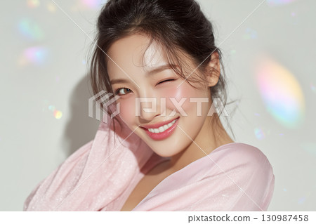 A cute wink from a female idol wrapped in pink and light 130987458