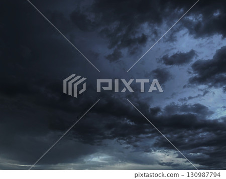 Background image of a black-gray cloudy sky with rain clouds 130987794