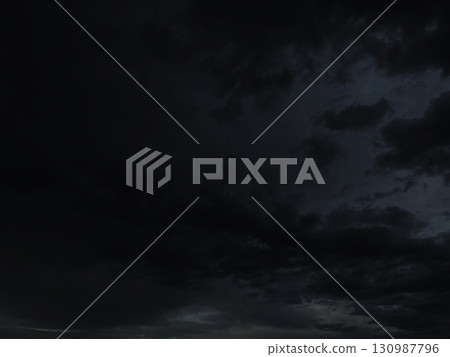 Background image of a black cloudy sky with rain clouds 130987796