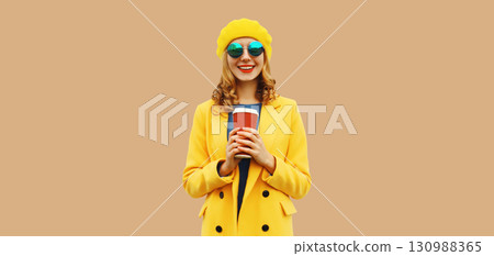 Autumn portrait of beautiful happy smiling young woman with cup of coffee drink in yellow french hat Autumn portrait of beautiful happy smiling young woman with cup of coffee drink in yellow french hat 130988365