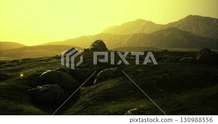 Soft golden sunlight bathes rolling hills, highlighting large boulders on the green terrain. Glowing insects flit through the warm air, creating a peaceful atmosphere during twilight. Soft golden sunlight bathes rolling hills, highlighting large boulders on the green terrain. Glowing insects flit through the warm air, creating a peaceful atmosphere during twilight. 130988556