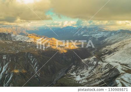 Caucasus Mountains Radiating Sunlight and Majestic Charm 130989871