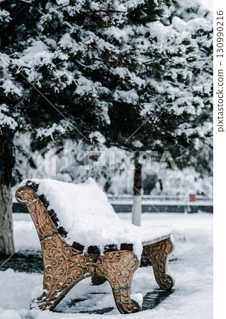 Snowy bench in winter park. Snowy bench in winter park. 130990216