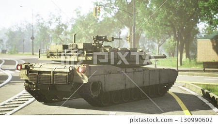 A military tank navigates a city street under sunny conditions. Surrounding trees offer shade while traffic signals regulate movement nearby. The scene captures urban infrastructure. A military tank navigates a city street under sunny conditions. Surrounding trees offer shade while traffic signals regulate movement nearby. The scene captures urban infrastructure. 130990602