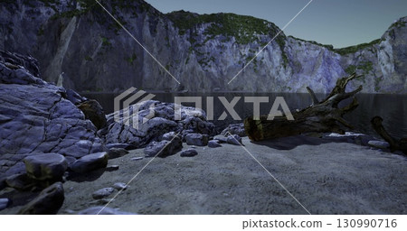 A tranquil lakeside setting unfolds with rocky formations and towering cliffs. 130990716
