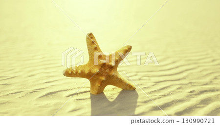 A solitary golden starfish lies on the smooth, sunlit sand of a peaceful beach. Gentle waves ripple in the background, creating a serene atmosphere at twilight. 130990721