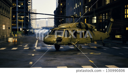 A military helicopter sits silently on a deserted city street, surrounded by tall buildings. The environment appears to have experienced a significant disruption, evoking curiosity. 130990806