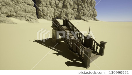 A wooden staircase stands alone in a vast sandy area, flanked by towering rocky cliffs on one side. The bright blue sky adds contrast, creating an otherworldly atmosphere. 130990931
