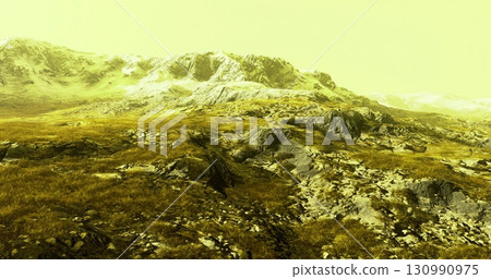 A vast mountain landscape features rugged rocks and patches of grass, with towering snow capped peaks in the background against a striking yellow sky during daytime. A vast mountain landscape features rugged rocks and patches of grass, with towering snow capped peaks in the background against a striking yellow sky during daytime. 130990975