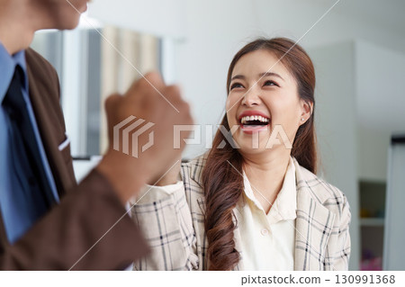 Joyful businesswoman celebrating success in a professional meeting Joyful businesswoman celebrating success in a professional meeting 130991368