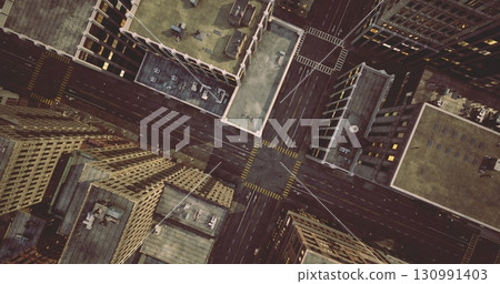 Aerial view captures a vibrant urban landscape with tall buildings and a busy intersection. Streets are lined with city structures creating a dynamic cityscape. 130991403