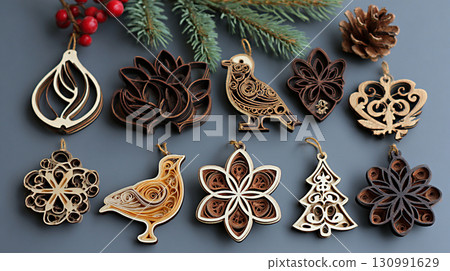 Wooden Christmas ornaments in various shapes including birds, flowers, and snowflakes. Decorated with pine cones and greenery. 130991629
