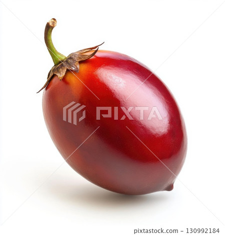 Fresh tamarillo fruit resting on a clean surface capturing its smooth texture and oval shape 130992184
