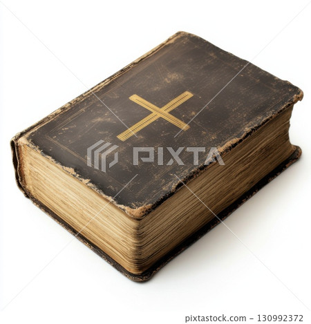 Old leather-bound Bible book with cross symbol resting on a surface, showing wear and age Old leather-bound Bible book with cross symbol resting on a surface, showing wear and age 130992372