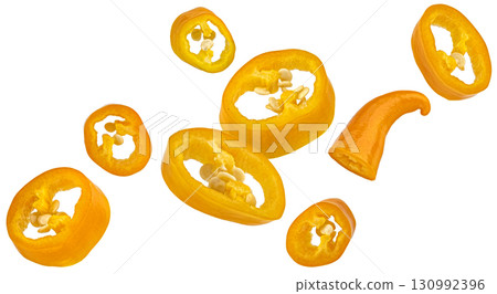 Falling chili pepper slices isolated on white background with clipping path, package design element, full depth of field Falling chili pepper slices isolated on white background with clipping path, package design element, full depth of field 130992396