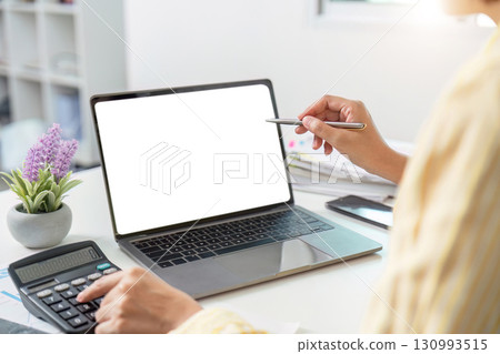 Remote Work. Professional presenting data on laptop in a modern office. Remote Work. Professional presenting data on laptop in a modern office. 130993515