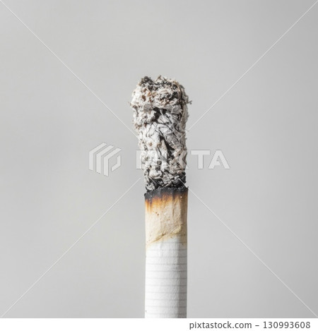 Close-up of a burning cigarette with ash on top 130993608