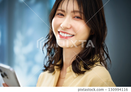 Woman operating a smartphone Woman operating a smartphone 130994116