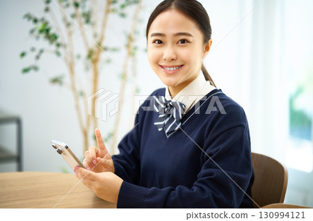 High school girl operating a smartphone 130994121