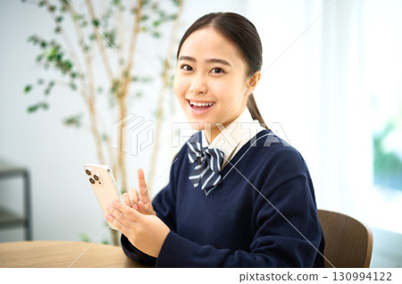 High school girl operating a smartphone 130994122