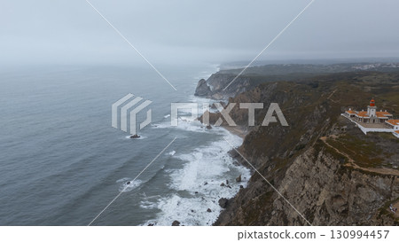 Aerial View of Cabo da Roca Lighthouse and Atlantic Ocean Cliffs in Portugal 130994457
