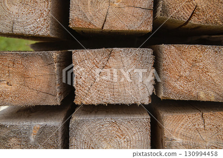 material for construction wooden beams close-up, building materials warehouse 130994458