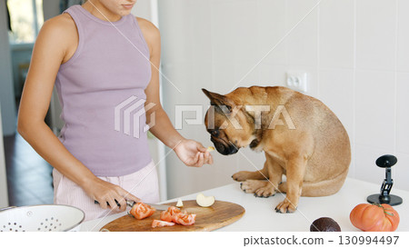 Preparing Delicious Food with a Loving Dog Companion in a Cozy, Inviting Kitchen Space Preparing Delicious Food with a Loving Dog Companion in a Cozy, Inviting Kitchen Space 130994497
