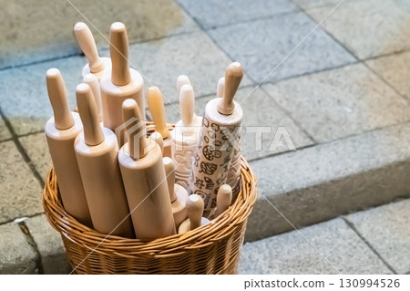 wicker basket with door rolling pins with a pattern to create an autumn pattern 130994526