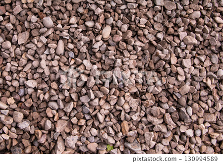 brown stone background from gravel close-up, lots of cobblestones brown stone background from gravel close-up, lots of cobblestones 130994589