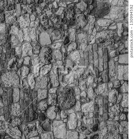 gray stone background of stacked cobblestones upright pattern closeup 130994592