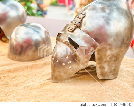 helmet with visor with slits for the eyes iron close-up on a blurred helmet background 130994608