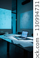 Modern Tech Conference Room: A sleek, contemporary conference room illuminated with cool blue lighting, featuring a laptop displaying data on the table alongside scattered documents. 130994731