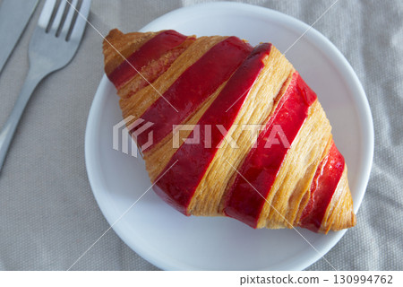 Raspberry jam croissant on a plate Raspberry jam croissant on a plate 130994762
