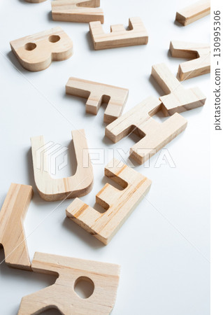Wooden alphabet blocks on white surface 130995306