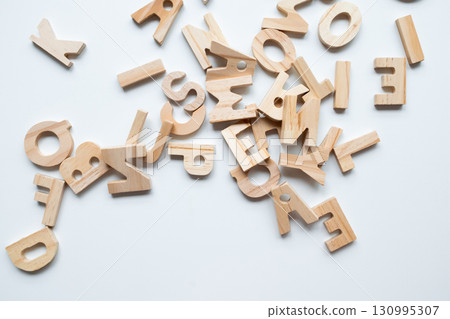 Wooden alphabet letters scattered randomly on white background Wooden alphabet letters scattered randomly on white background 130995307