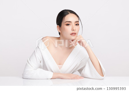 A beautiful young Asian woman with clean, fresh skin against a white background. Skincare, facial treatment, cosmetology, beauty, and spa. An elegant portrait of an Asian woman. A beautiful young Asian woman with clean, fresh skin against a white background. Skincare, facial treatment, cosmetology, beauty, and spa. An elegant portrait of an Asian woman. 130995393