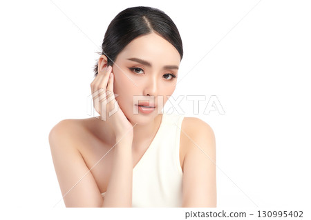 A beautiful young Asian woman with clean, fresh skin against a white background. Skincare, facial treatment, cosmetology, beauty, and spa. An elegant portrait of an Asian woman. A beautiful young Asian woman with clean, fresh skin against a white background. Skincare, facial treatment, cosmetology, beauty, and spa. An elegant portrait of an Asian woman. 130995402