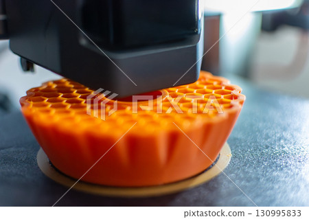 3d printer printing an object on the tray with pla filament, corn starch, non-waterproof filament 3d printer printing an object on the tray with pla filament, corn starch, non-waterproof filament 130995833