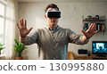 Gamer with Gamepad and VR Headset 130995880