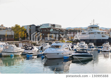 View of a vibrant marina featuring docked boats. Levanger, Norway 130995888