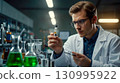 Scientist Conducts Experiment with Chemical Substances 130995922