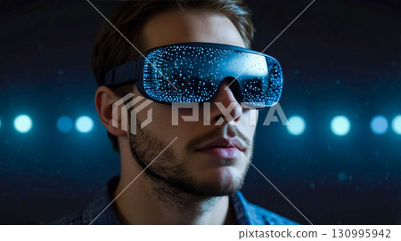Man in VR Headset Against Glowing Lights 130995942