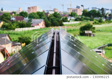 Solar photovoltaic panels on roof. Installation of solar batteries on rooftop of house. Concept of alternative energy sources in modern life. Solar photovoltaic panels on roof. Installation of solar batteries on rooftop of house. Concept of alternative energy sources in modern life. 130996225