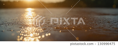 Concept of rain, sun and water. Drops of water shimmer in the backlight. Bright orange background. 130996475