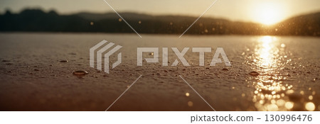 Concept of rain, sun and water. Drops of water shimmer in the backlight. Bright orange background. 130996476