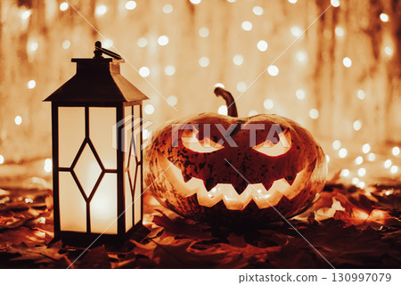 Concept of halloween pumpkin. Beautiful pumpkin with lantern on Autumn leaves Concept of halloween pumpkin. Beautiful pumpkin with lantern on Autumn leaves 130997079