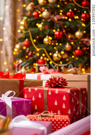 Many bright gifts, presents under Christmas tree. Christmas background 130997092
