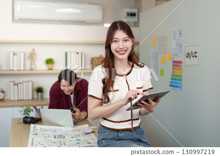 Young Designer Using Tablet for UX UI Project 130997219